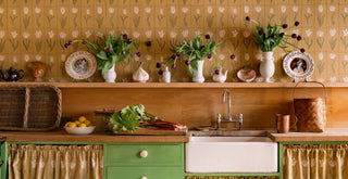 Vintage-style kitchen with wooden cabinets, a sink, and molly mahon botanica tulip wallpaper in gold and olive.
