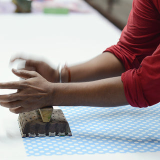 Master craftsman block printing Molly Mahon's design blue polka dot used for table cloths and napkins