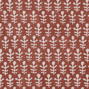 A close-up of a terracotta-colored wallpaper with a repeating off-white botanical leaf pattern.