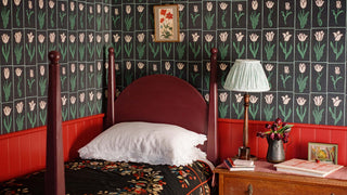 Luxury printed tulip wallpaper in green and black tones styled in a bedroom