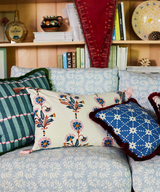 Image of Molly Mahon's new collection of cushions lying across a sofa in Molly Mahon's cool blue Ashdown fabric.