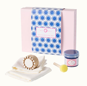 Block printing kit with packaging, wooden block, ink pad, and cloths on a white background